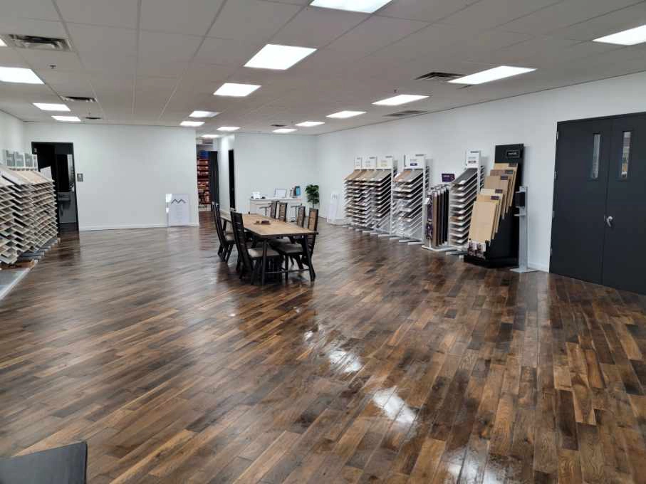Commercial painting services in Austin, Texas showroom with wood flooring, paint sample racks, and consultation tables.