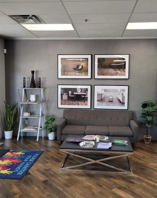 Commercial painting services in Austin, Texas showroom with framed wall art, seating area, and decorative plants.