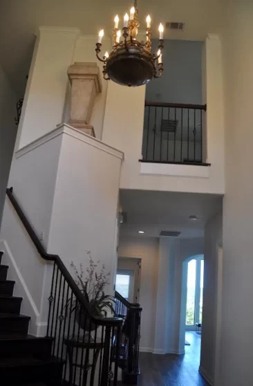 Painted stairway interior with chandelier by expert painters in Austin, TX